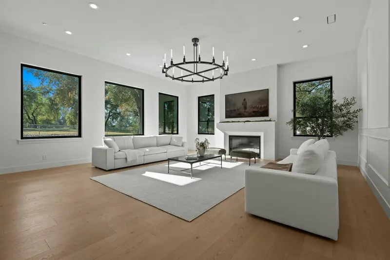 Bright living room with pale oak floors and a fireplace